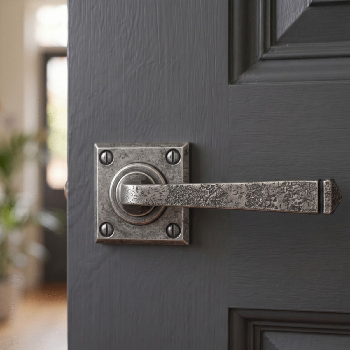 The "Airedale" Sprung Pewter Iron Door Handle Set on a Dark Grey Door in a Modern Home Hallway - Digital Illustration