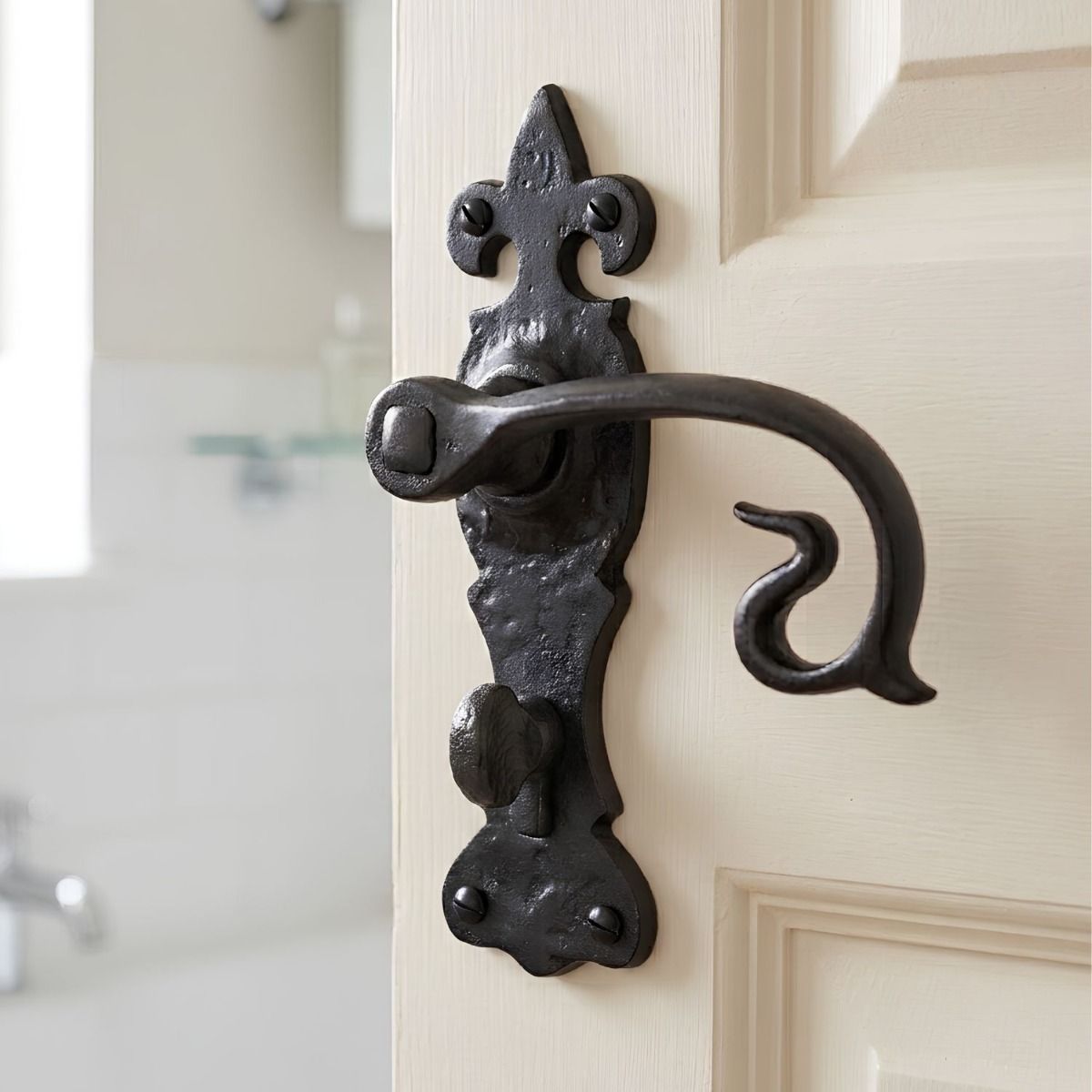 The "Alvito" Black Curly Lever Bathroom Set on a Cream Coloured Door with an Integrated Thumbturn Lock - Digital Illustration