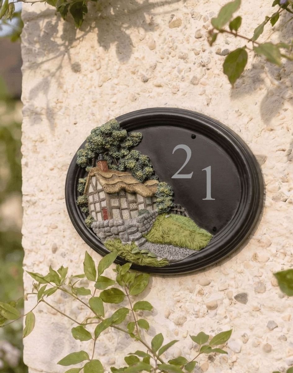 The "Avenbury Thatch" Hillside Cottage Oval House Sign on a Rustic Cottage Wall - Digital Illustration 