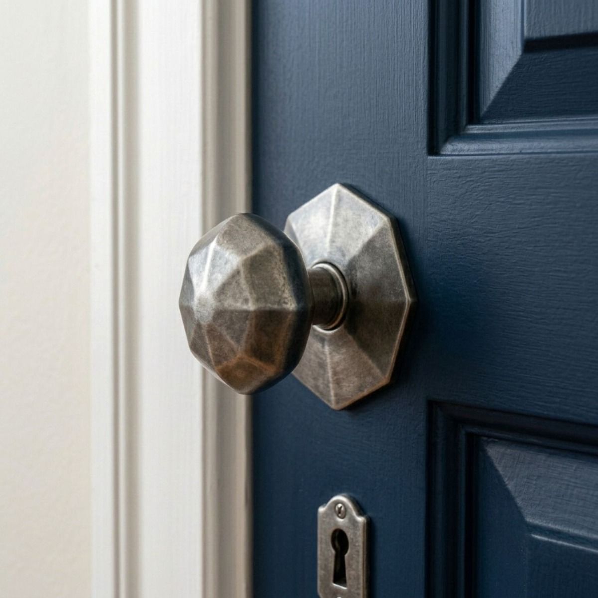 The "Beaufort" Pewter Patina Octagonal Centre Door Knob Fitted on a Blue Door in a Modern Home - Digital Illustration