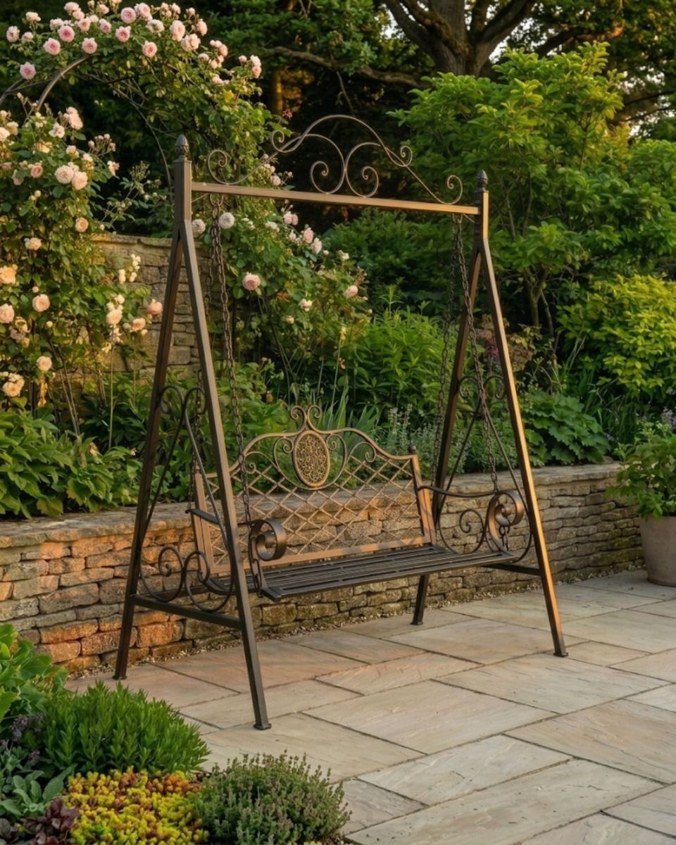 The "Blenheim" Ornate Arched Garden Swing Seat on a Sunny Garden Patio in a Black Finish - Digital Illustration