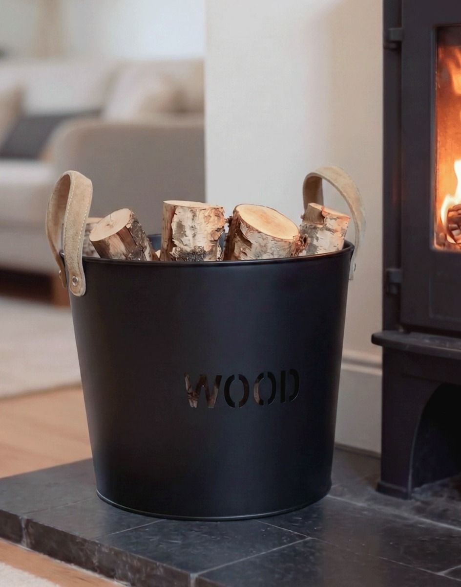 The "Brettington" Powder Coated Iron Wood Basket on a Black Stone Fireplace in a Modern Home - Digital Illustration