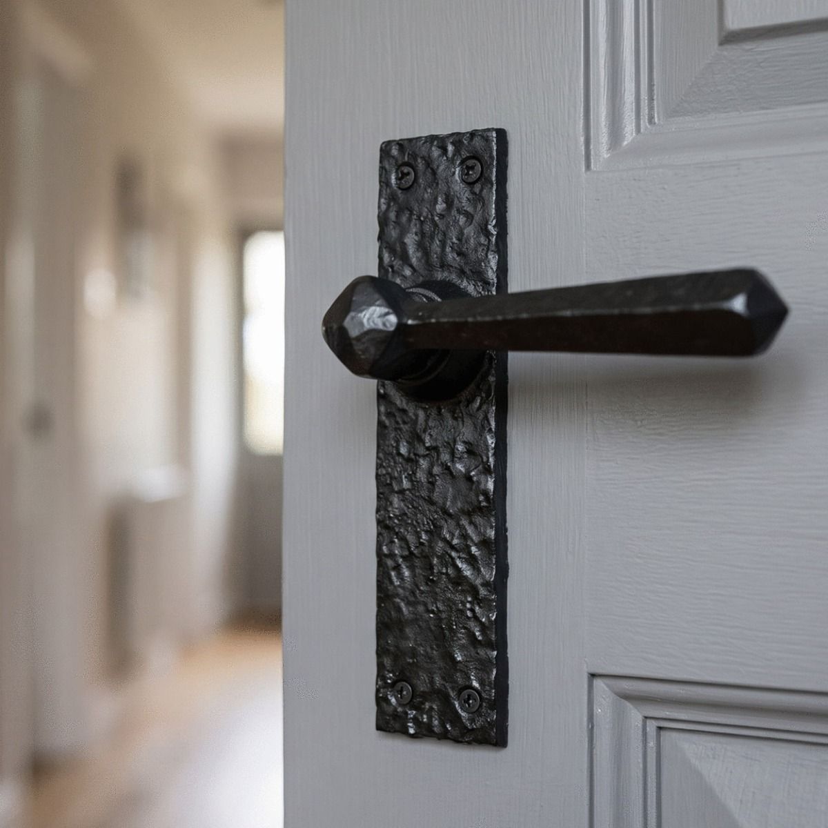 The "Brookston" Rectangular Lever Handle on an Open Grey Door - Digital Illustration 