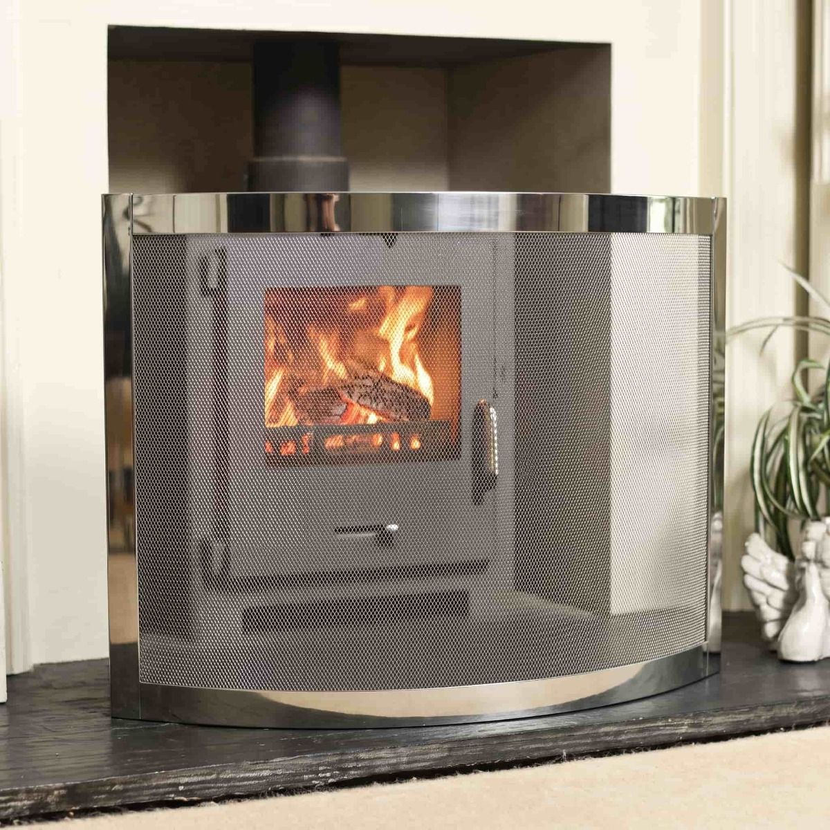 The "Carrowdrock" Contemporary Curved Bespoke Fire Guard Positioned in front of a Lit Log Burner Stove - Digital Illustration 