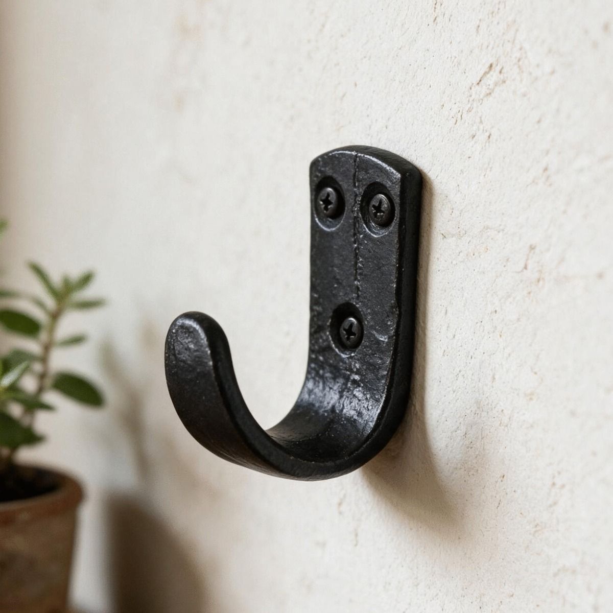 The "Dareshill" Iron Coat Hook Fitted onto a White Wall in a Modern Home - Digital Illustration