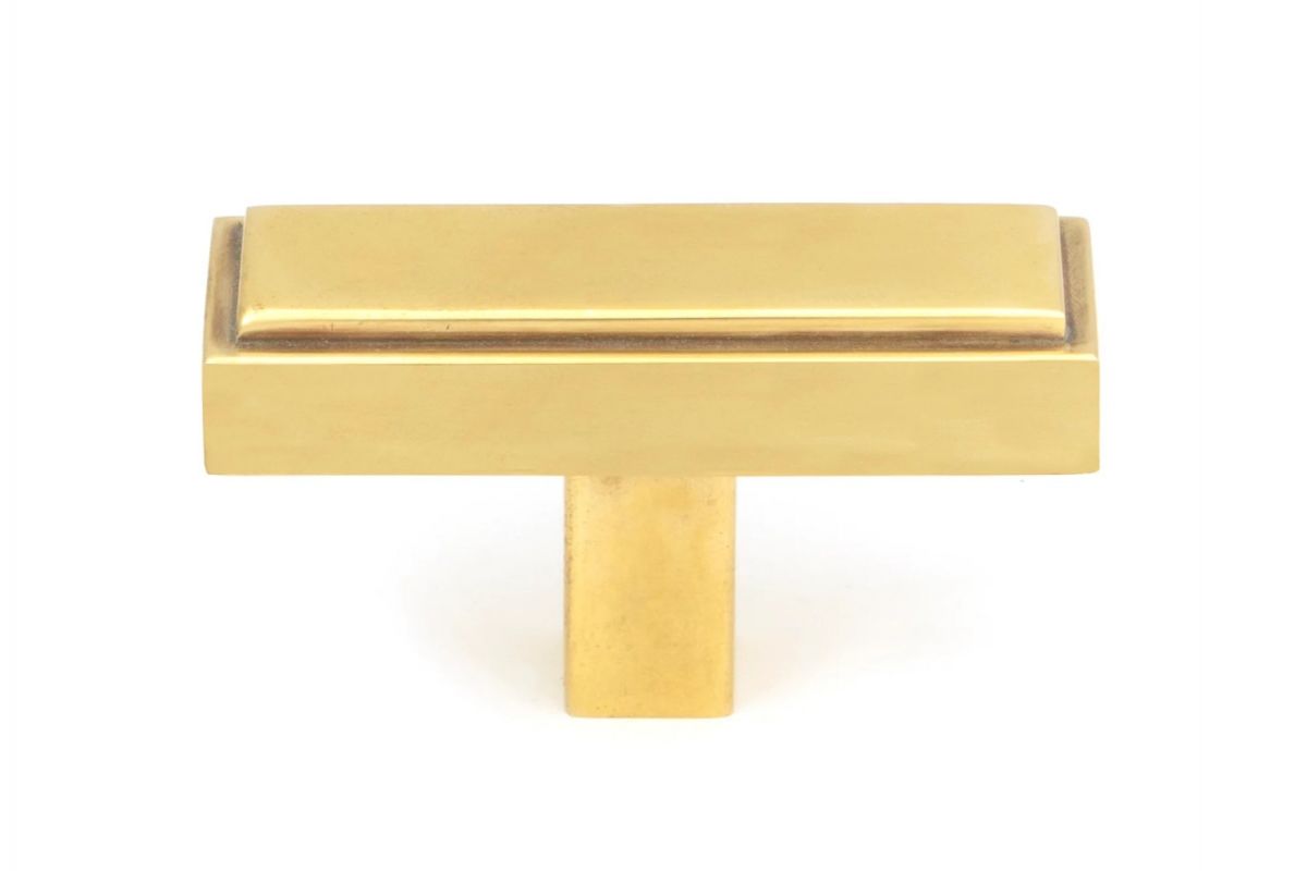 The "Emerson" Rectangular T-Bar Cabinet Pull Handle in an Aged Brass Finish on a White Background Shown Front on