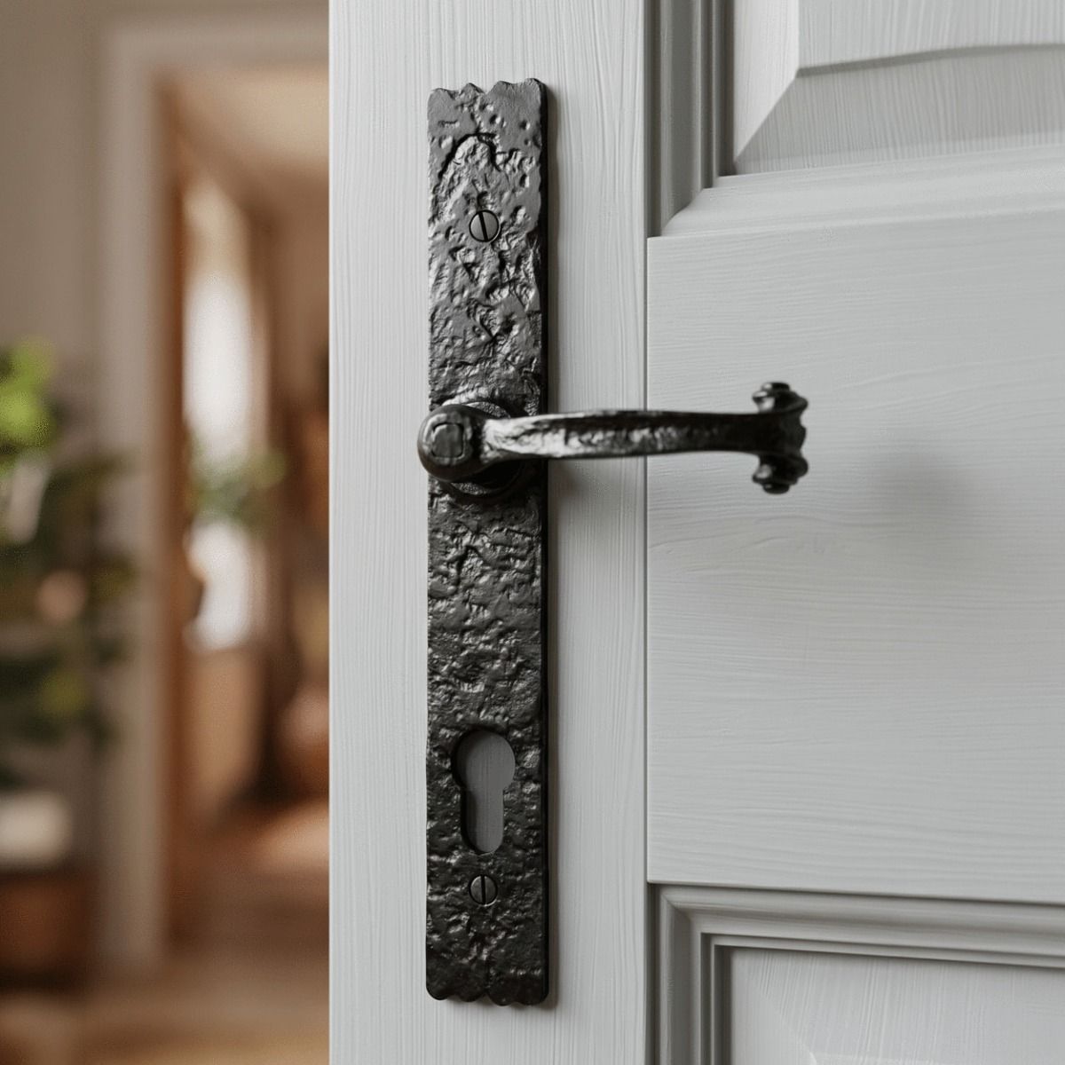 The "Farrington" Long Profile Cast Iron Lever Handle With Key Hole on a Light Grey Door in a Sunny Home - Digital Illustration