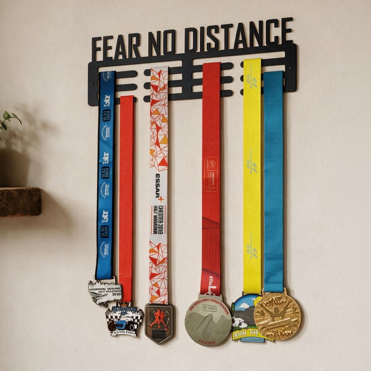 The "Fear No Distance" Sports Medal Hanger on a Cream Wall Shown From a Low Angle in a Home - Digital Illustration