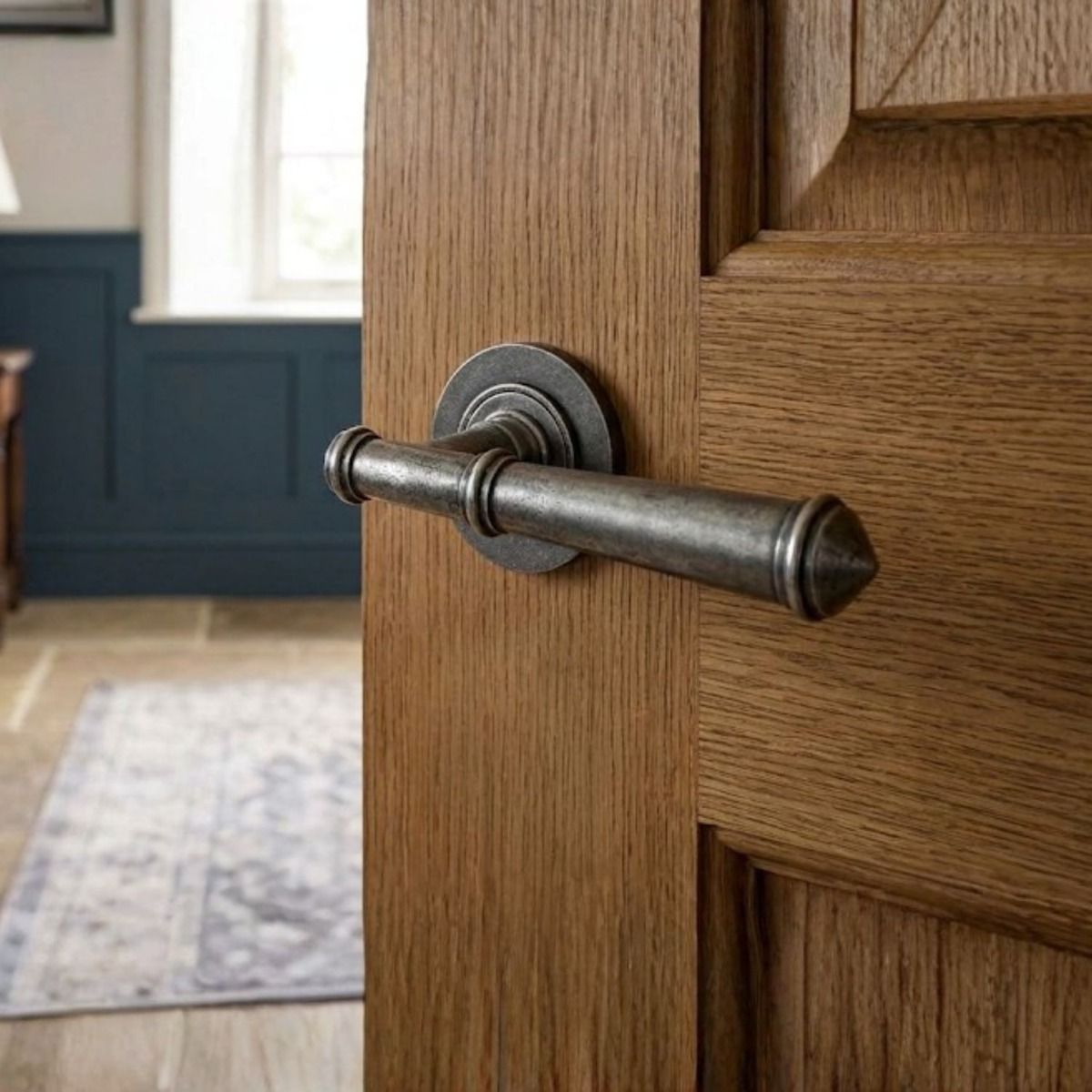 The "Hadley Gardens" Antique Pewter Unsprung Lever Door Handle on Rose on a Door in a Traditional Home - Digital Illustration 