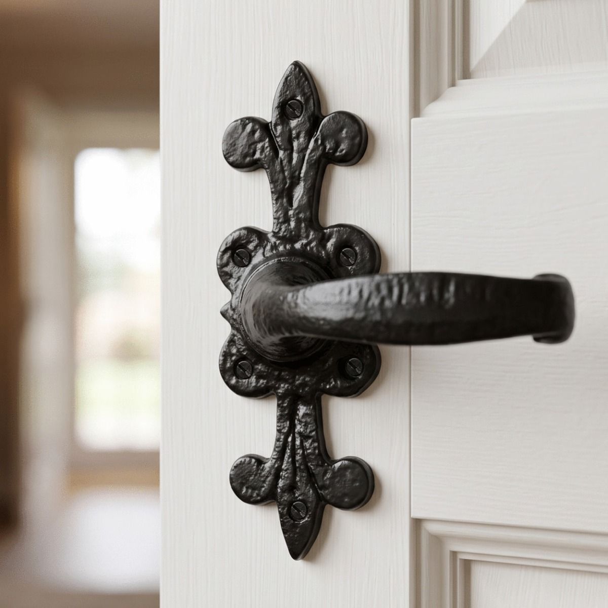 The "Harrington Keep" Traditional Fleur de Lys Lever Handle Shown Close up on a White Timber Door - Digital Illustration 