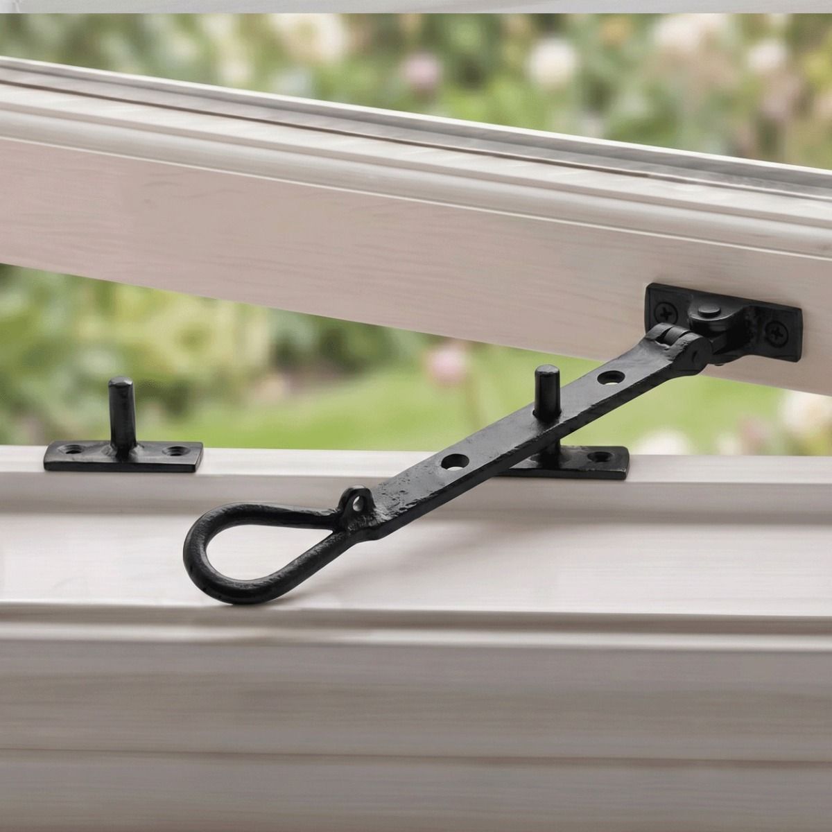 The "Hartlake Park" Cast Iron Window Stay Fitted on a White Open Window Frame - Digital Illustration 