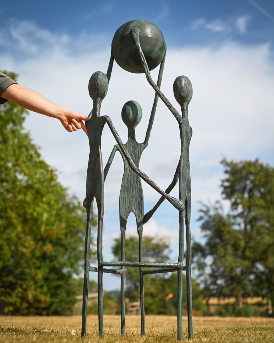 The "Lift" Cast Aluminium Garden Sculpture as a Garden Centrepiece with Hand in Shot for Scale