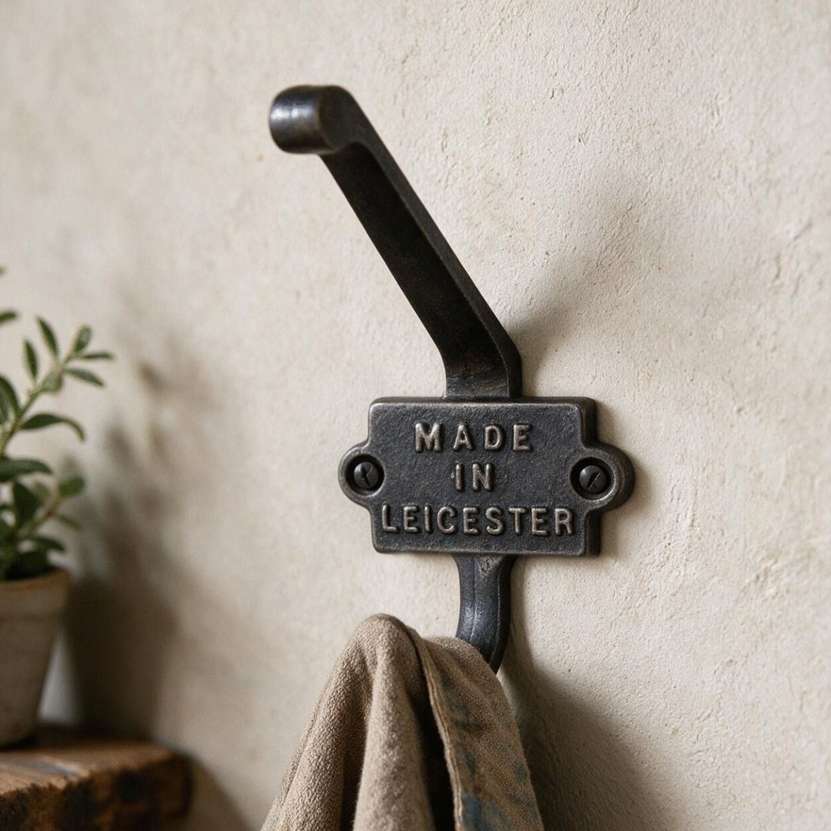 The "Made In Leicester" Iron Coat Hook in a Well Lit Hallway in a Home - Digital Illustration