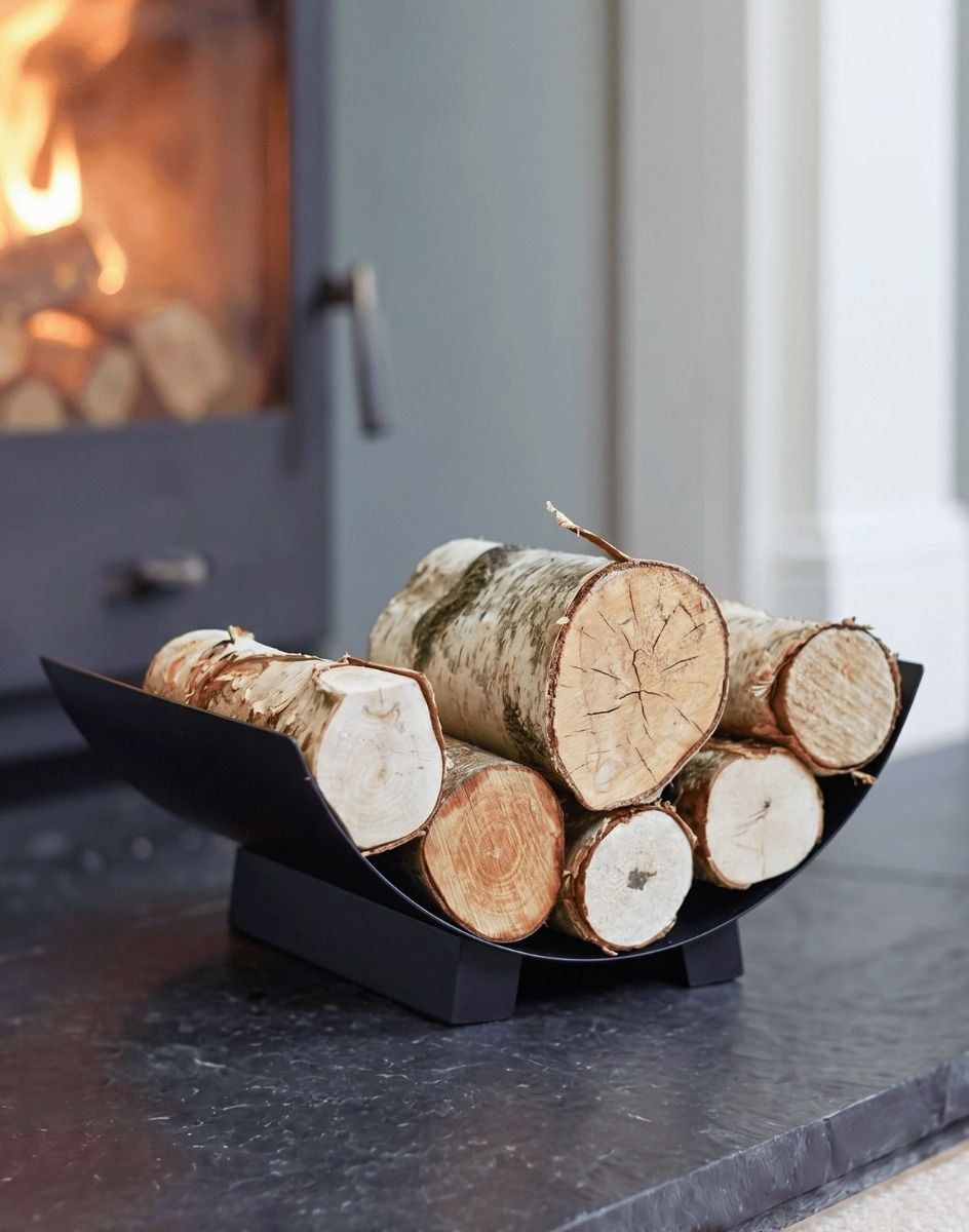 The "Media Luna" Contemporary Log Holder in Front of a Lit Log Burner Stove in a Modern Living Room Interior - Digital Illustration 