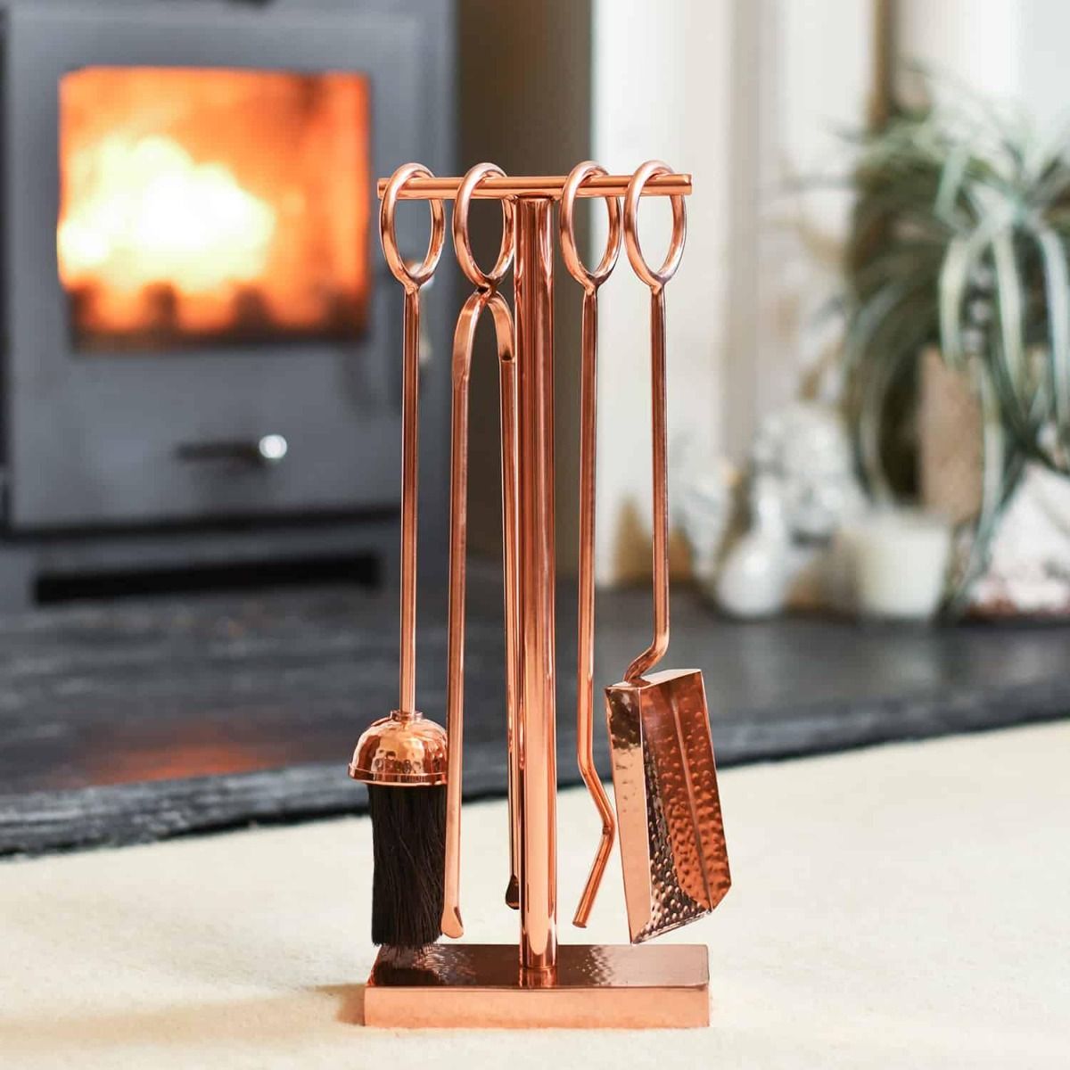 The "Middleton" Hammered Rose Gold Companion Set with a Wood Burner Stove Behind - Digital Illustration