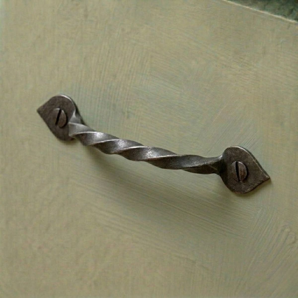 The "Mira" Twist Pull Handle Mounted on a Contemporary Green Kitchen Cabinet - Digital Illustration