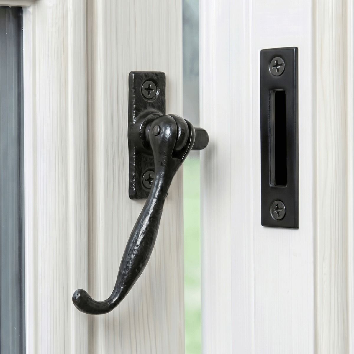 The "Ollerton Avenue" Contemporary Iron Casement Stay Mounted on a Traditional White Wooden Windowframe - Digital Illustration