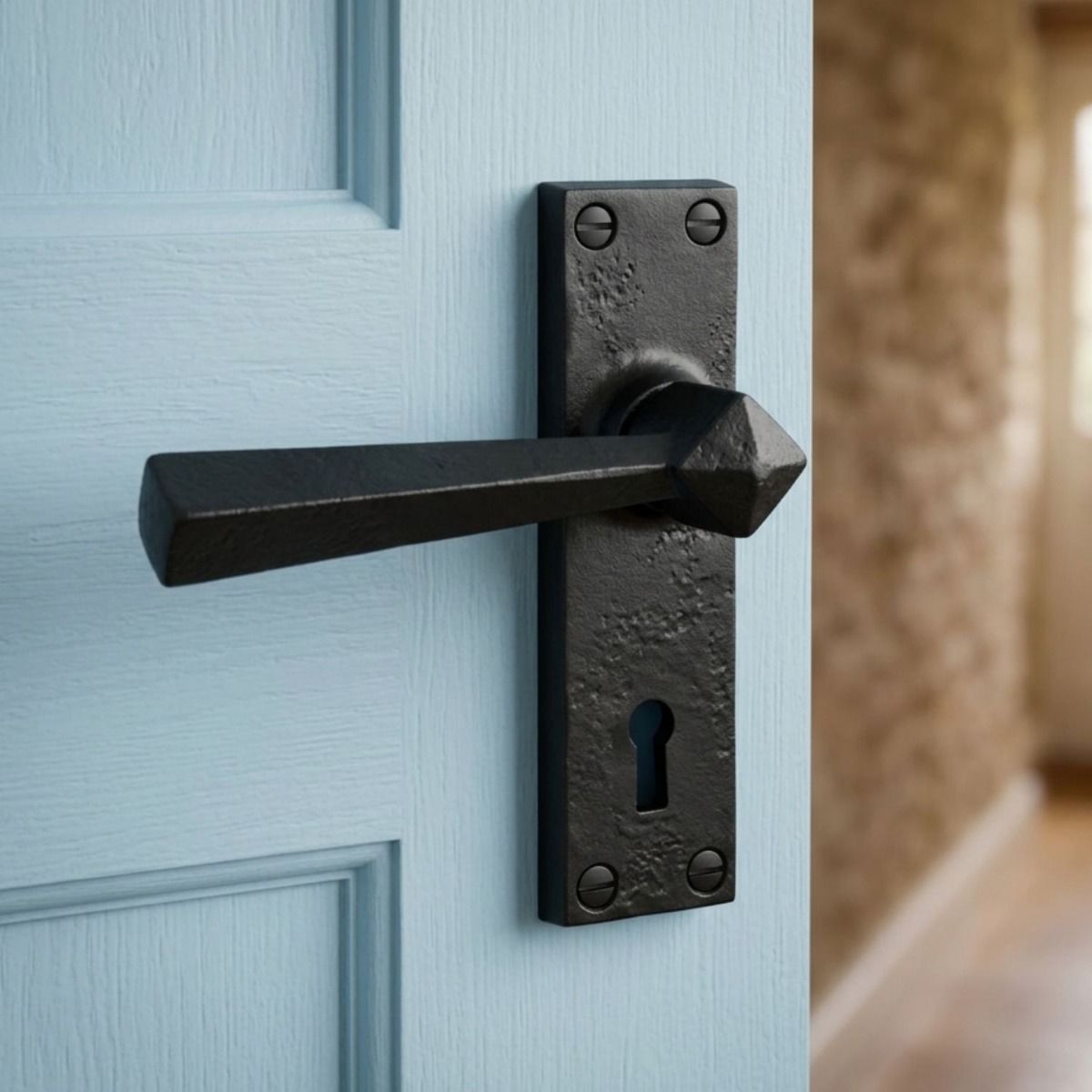 The "Peregrine" Black Straight Lever Lock Set with Keyhole Fitted to a Light Blue Door in a Country Home - Digital Illustration