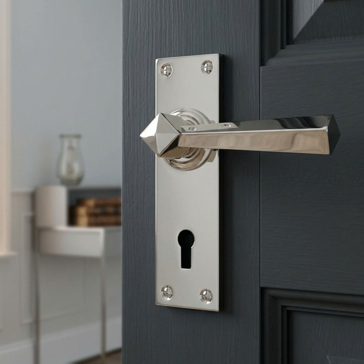 The "Peregrine" Bright Chrome Straight Lever Lock Set on a Grey Door in a Modern Home - Digital Illustration