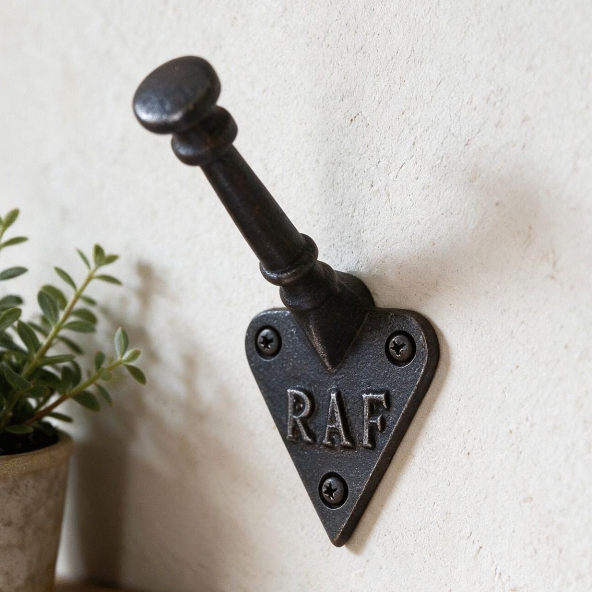 The "RAF" Iron Coat Hook Shown Close up on a White Wall - Digital Illustration