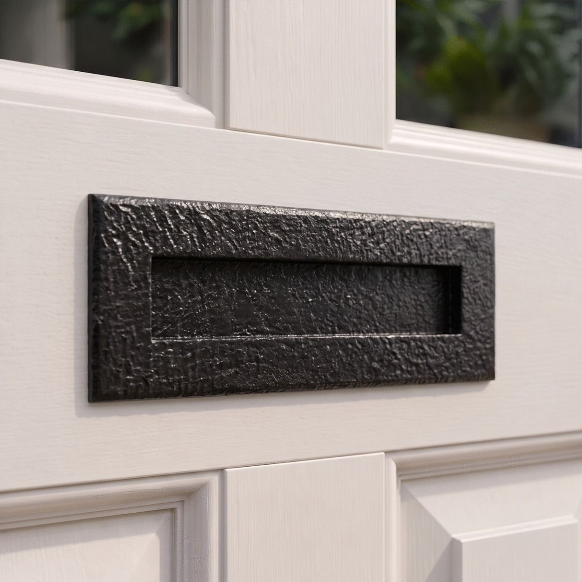The "Reaseheath" Blacksmith Style Iron Letter Plate on a White Painted Wooden Entrance Door to a Home - Digital Illustration