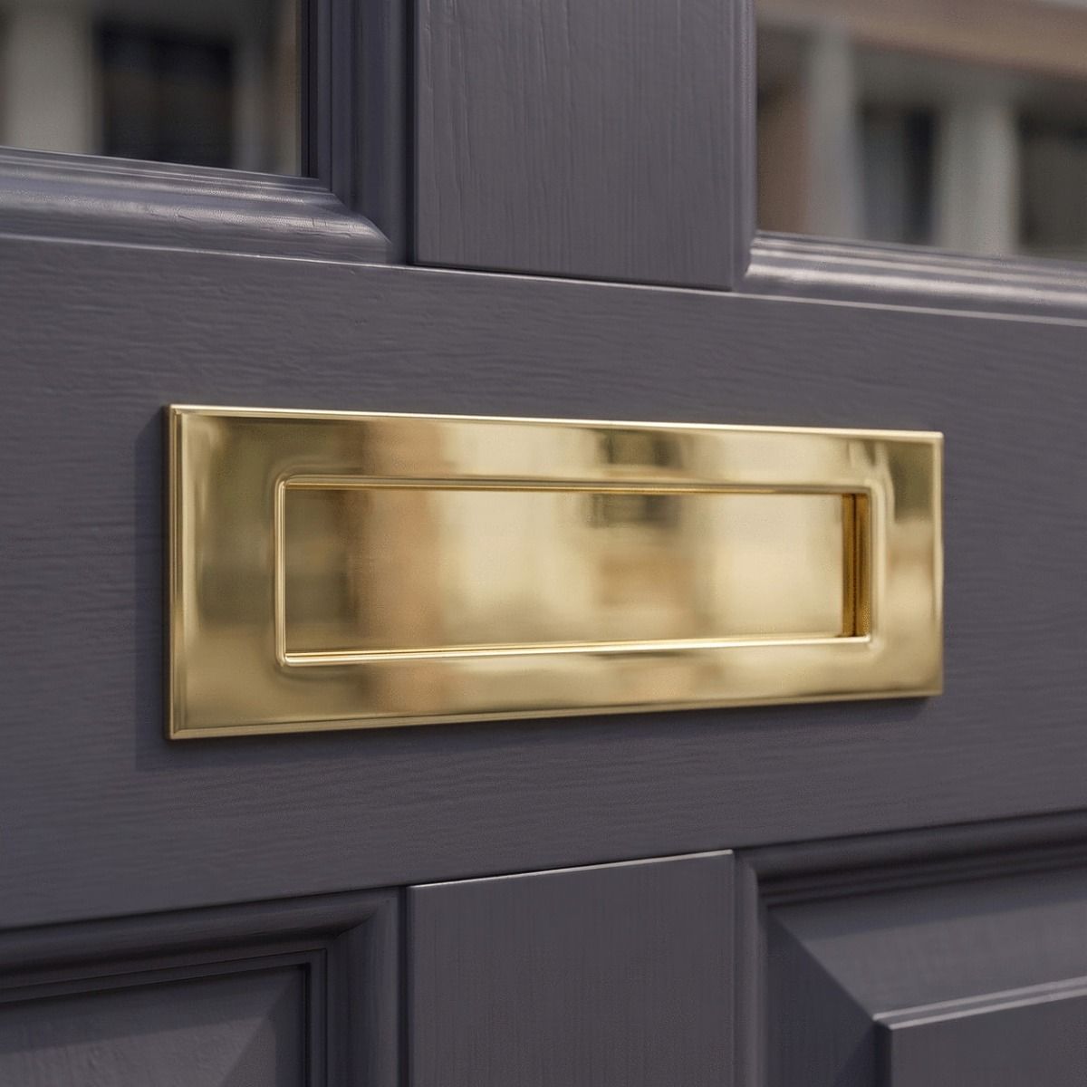 The "Sandhill" Cast Brass Letter Plate in a Brass Finish on a Dark Grey Coloured Front Door with Glass Panels - Digital Illustration 