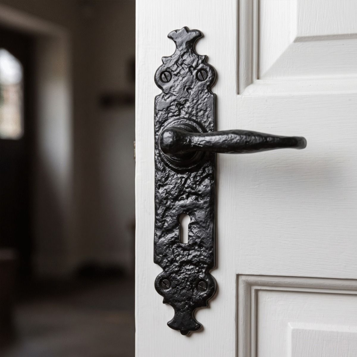 The "Shiredale" Antique Cast Iron Lever Handles with Key Hole on a White Wooden Door in a Traditional Home Hallway - Digital Illustration