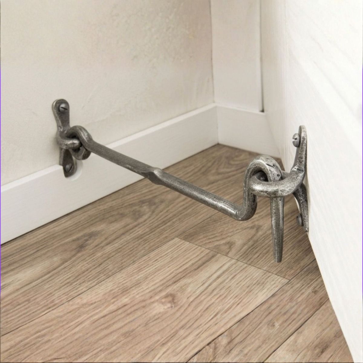 The "Siena" Pewter Forged Cabin Hook 12" on a Cupboard in a Modern Living Room