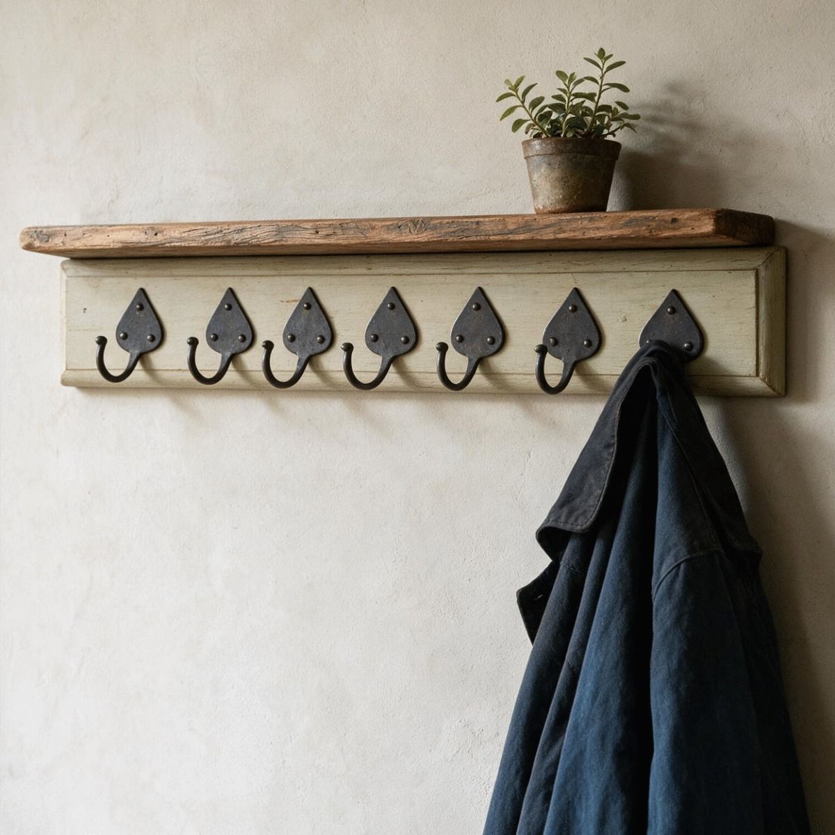 The "Taunton” Beeswax Coat Hooks on an Olive Green Rack Fitted to a Magnolia Coloured Wall - Digital Illustration