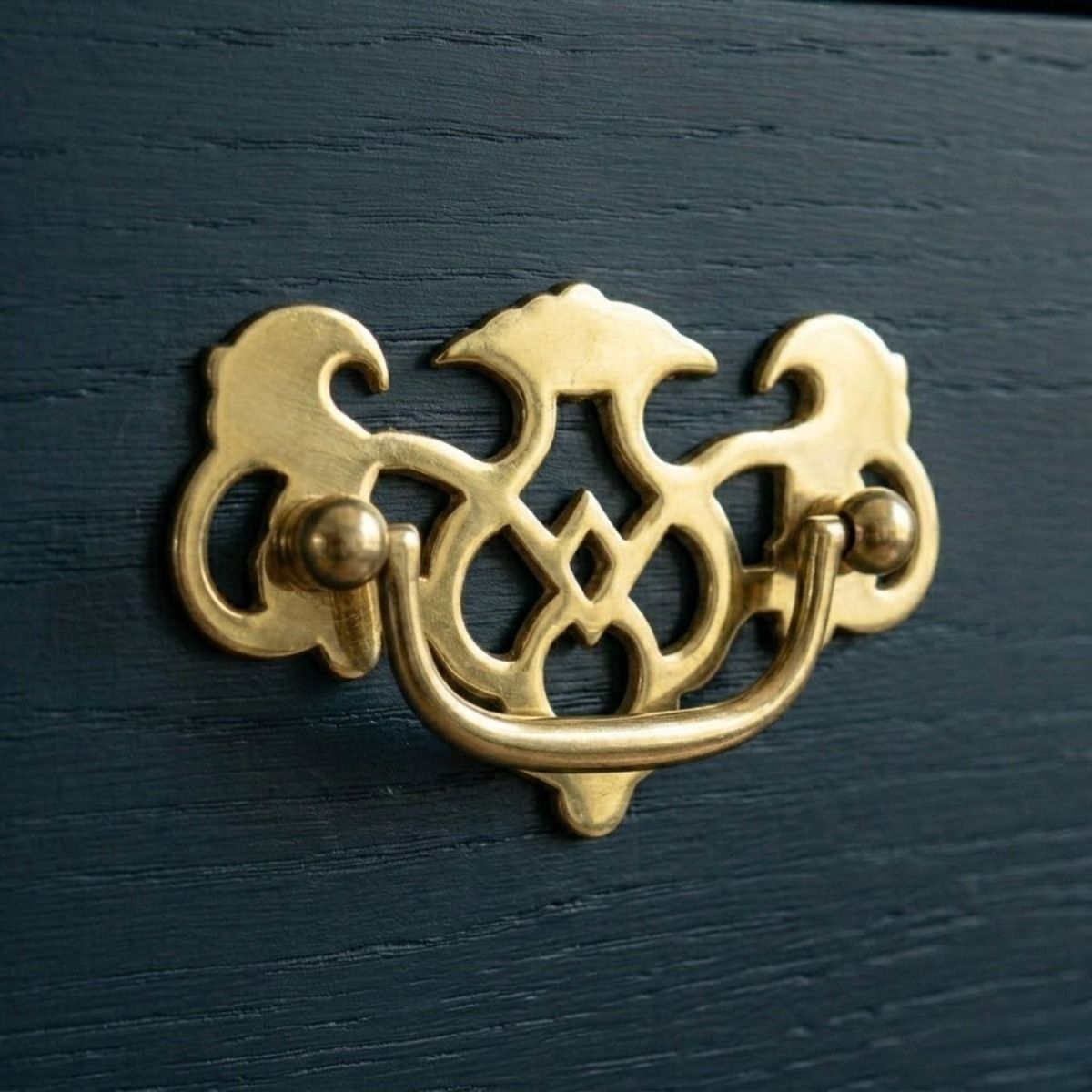 The "The Royal" Polished Brass Cabinet Pull Handle Mounted on a Rich Blue Wooden Kitchen Cabinet - Digital Illustration