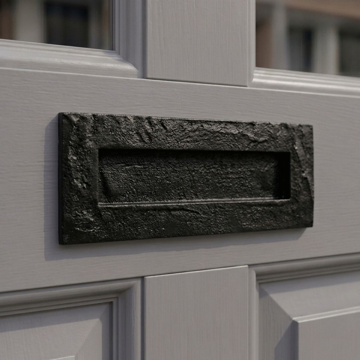 The "Torriedale" 10.5" Black Cast Iron Letter Plate on a Grey Home Door Entrance - Digital Illustration 