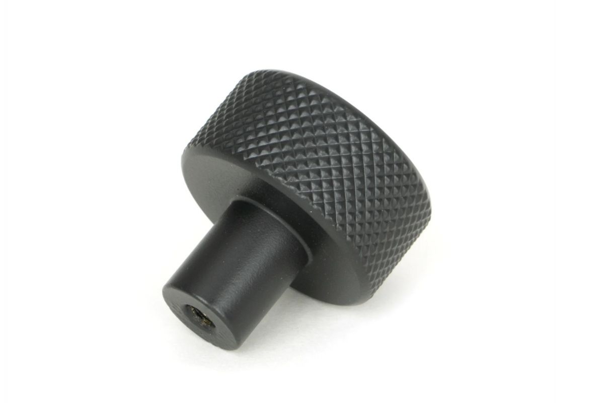 The 25mm "Vesper" Knurled Edge Cabinet Knob in Matt Black on a White Background Shown from Behind