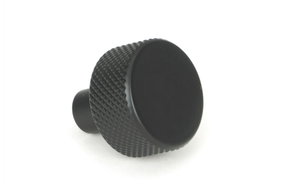 The 25mm "Vesper" Knurled Edge Cabinet Knob in Matt Black on a White Background Shown from the Side