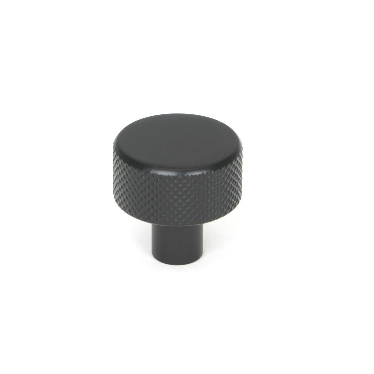 The 25mm "Vesper" Knurled Edge Cabinet Knob in Matt Black on a White Background Shown Stood Upright