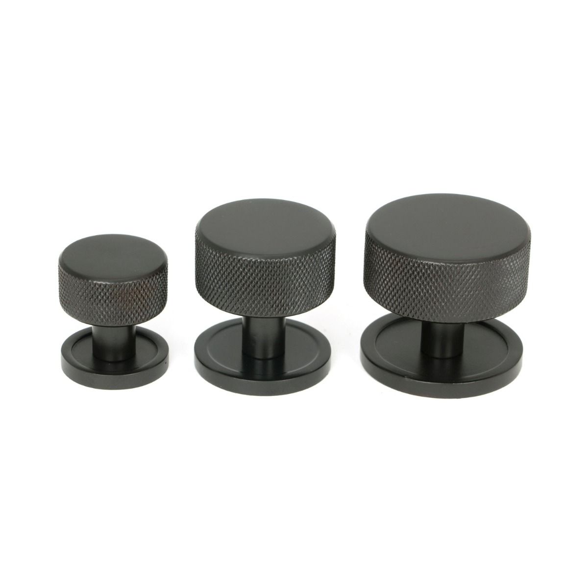 The 25mm Knurled Cabinet Knob on a Plain Rose in Aged Bronze Alongside Different Sizes 