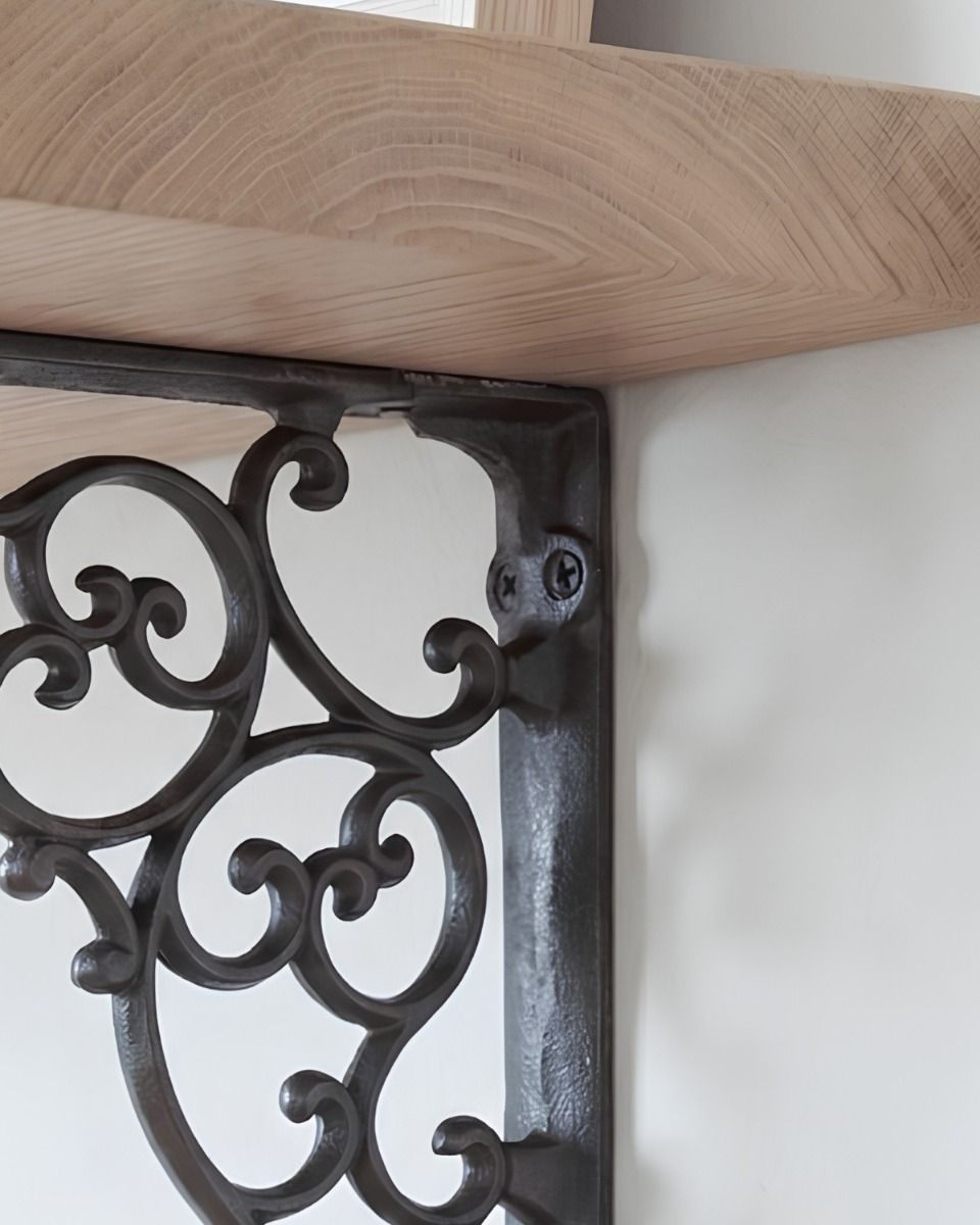 The 27.5cm x 20.5cm Cast Iron Ornate Scroll Shelf Bracket Showing a close up of the Integrated Screw Holes