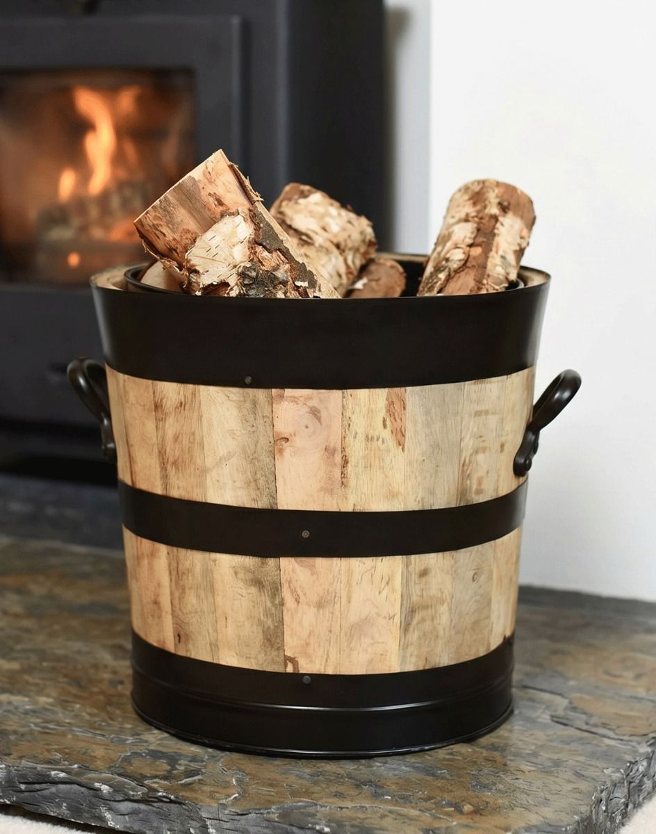 The 30cm Innsbruck Wooded Coal Scuttle shown with Logs Inside next to a Lit Log Burner Stove - Digital Illustration