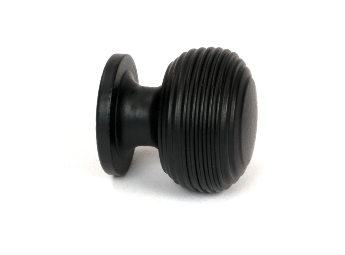 The 30mm "Garrison" Ribbed Beehive Knob in Matt Black on a White Background Displayed from the Side