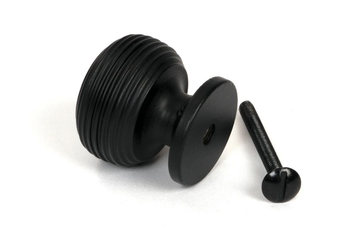 The 30mm "Garrison" Ribbed Beehive Knob in Matt Black on a White Background Shown from Behind with the Screw