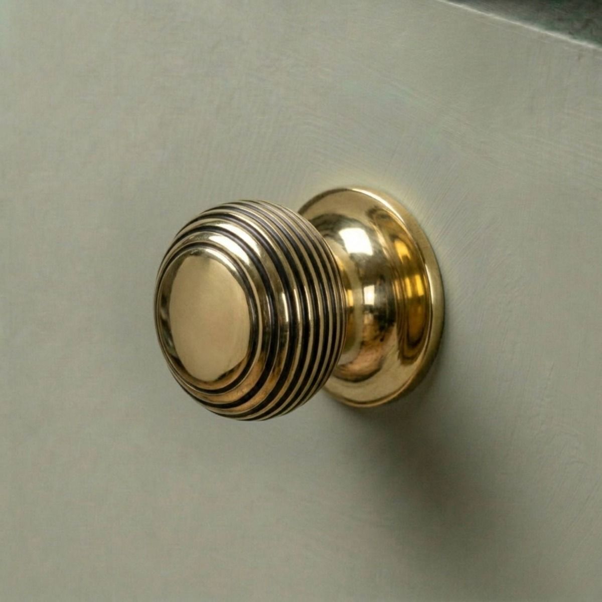 The 30mm Individual Aged Brass Beehive Cabinet Knob Fitted on a DIY Kitchen Cupboard in a Contemporary Home - Digital Illustration