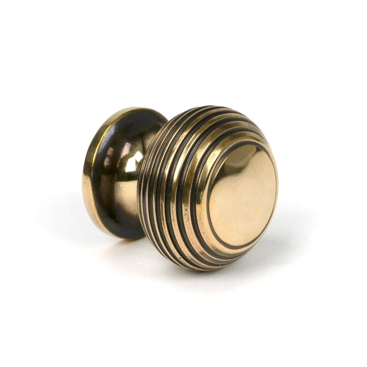 The 30mm Individual Aged Brass Beehive Cabinet Knob Viewed from the Side on a White Background