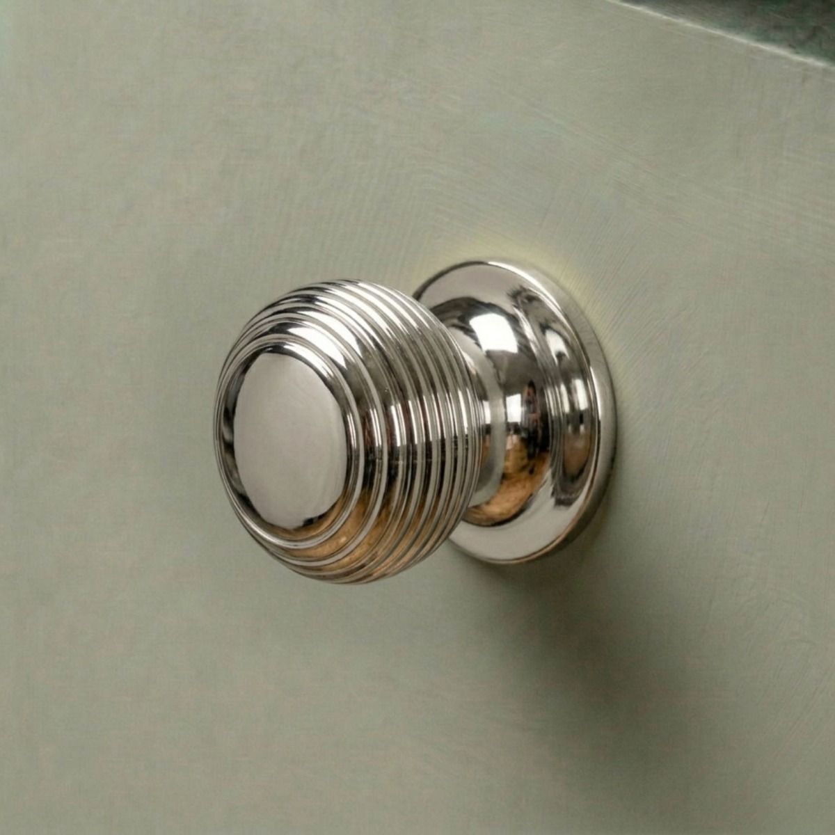 The 30mm Individual Polished Nickel Beehive Cabinet Knob Fitted on a Modern Kitchen Cupboard Drawer in Sage Green - Digital Illustration 