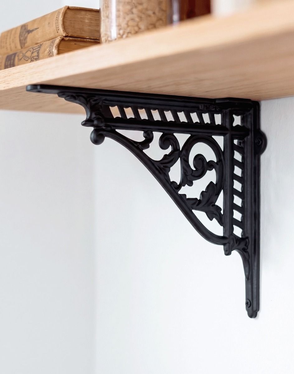 The 31 x 26cm Heritage Style Black Shelf Bracket Used as a DIY Shelf on a White Interior Wall - Digital Illustration
