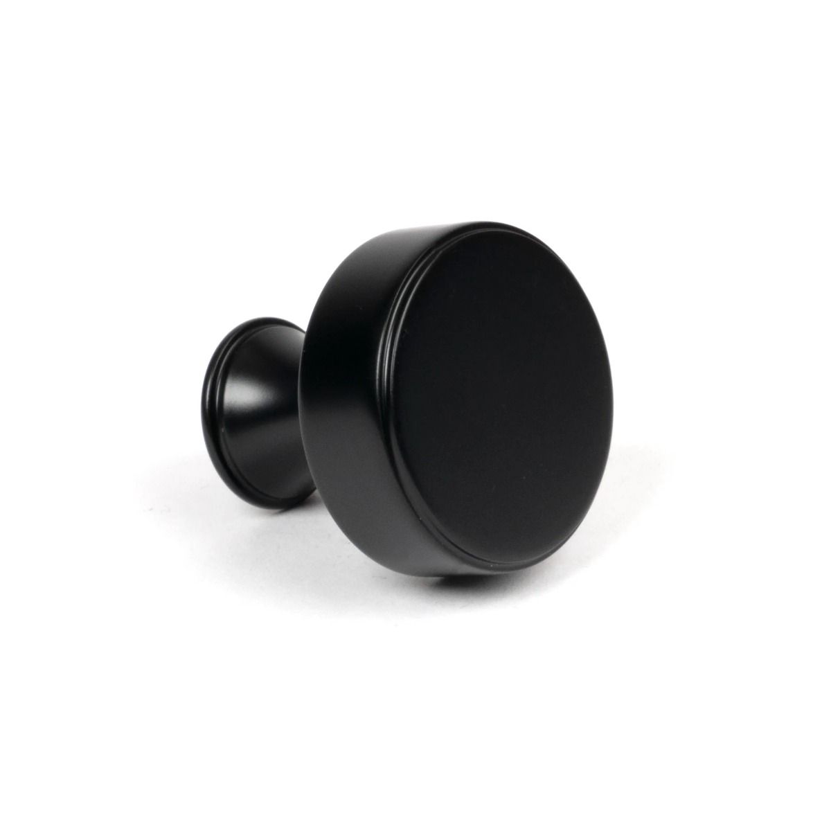 The 32mm "Atelier" Circular Cabinet Knob in Matt Black on a White Background Shown Side On