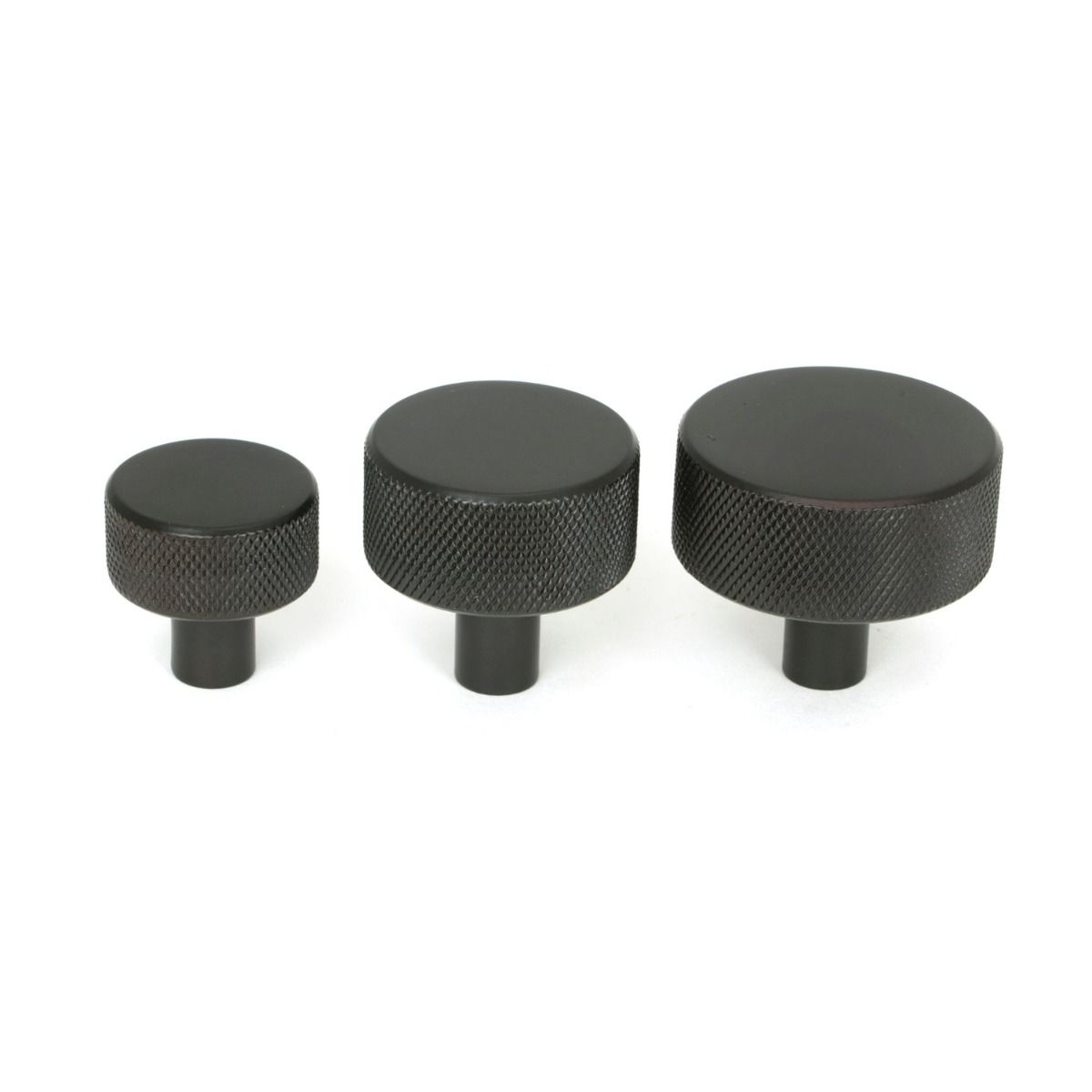 The 32mm Knurled Cabinet Knob (No Rose) in Aged Bronze Alongside Different Sizes
