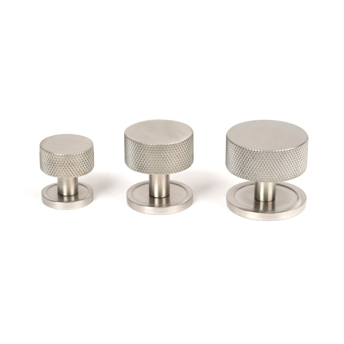 The 32mm Knurled Cabinet Knob on a Plain Rose in Satin Stainless Steel Alongside Different Sizes