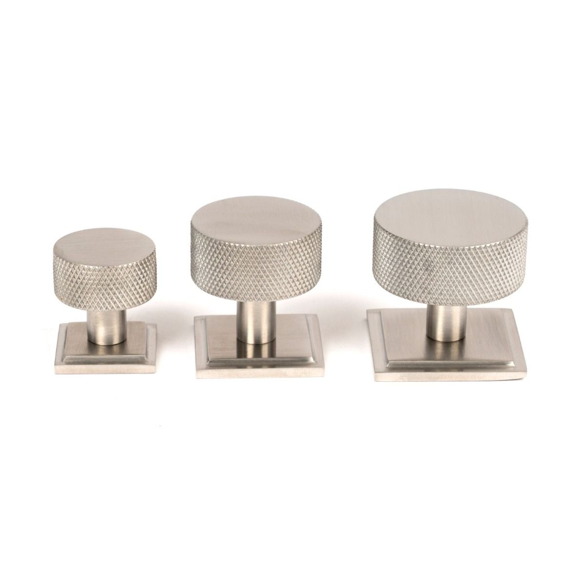 The 32mm Knurled Cabinet Knob on a Square Rose in Satin Stainless Steel Alongside Different Sizes