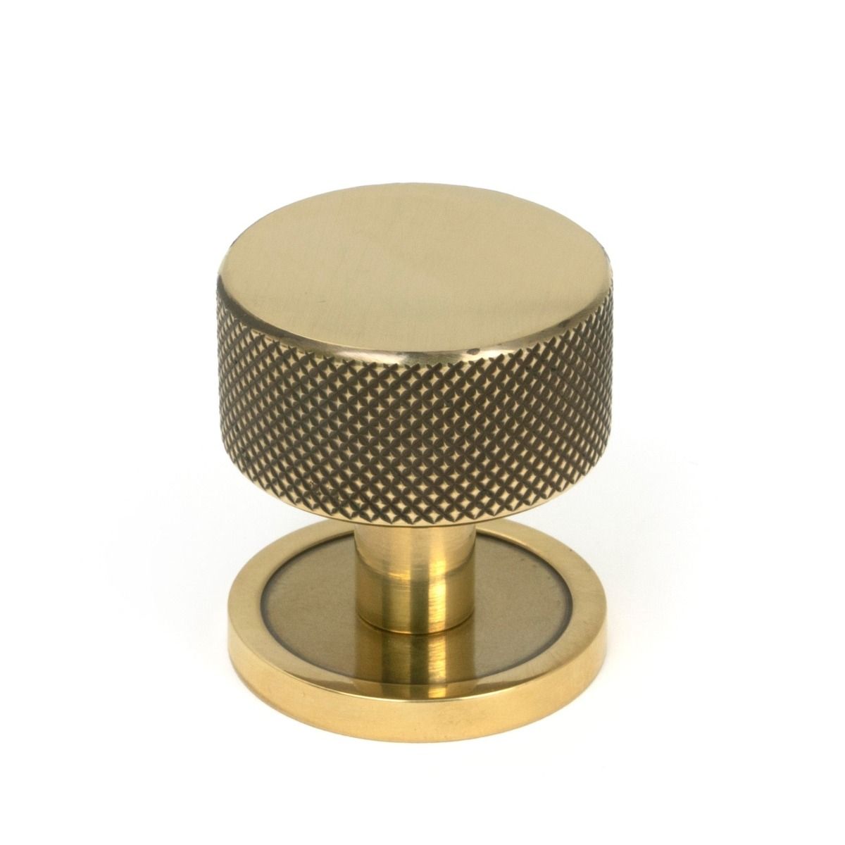 The 32mm Knurled Cabinet Knob on Plain Rose in Aged Brass Shown Upright on a White Background
