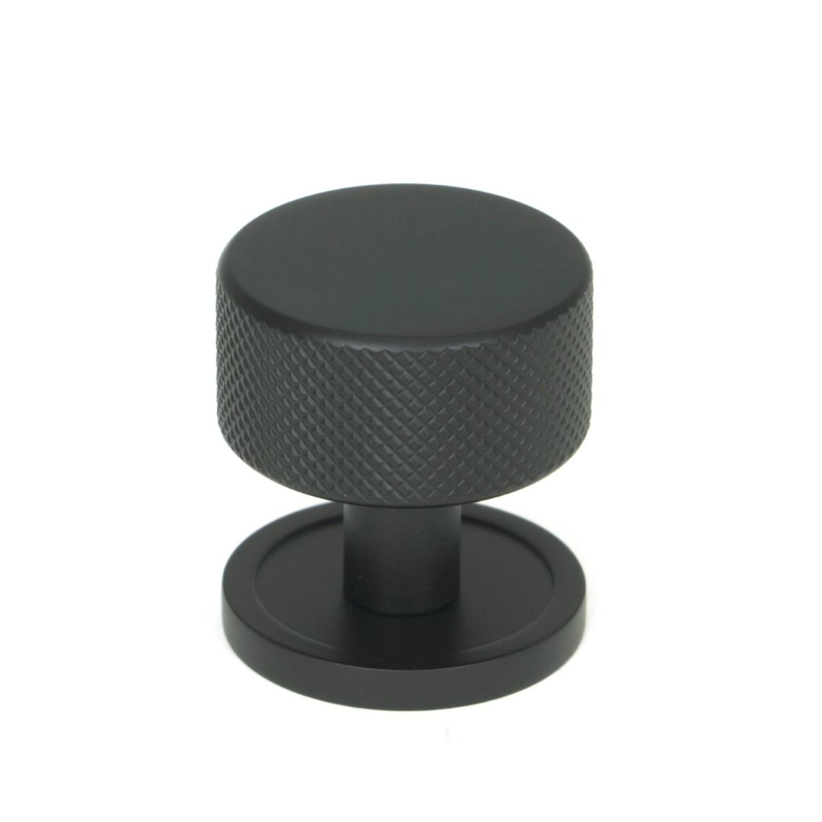 The 32mm Knurled Cabinet Knob on Plain Rose in Matt Black Shown Upright on a White Background