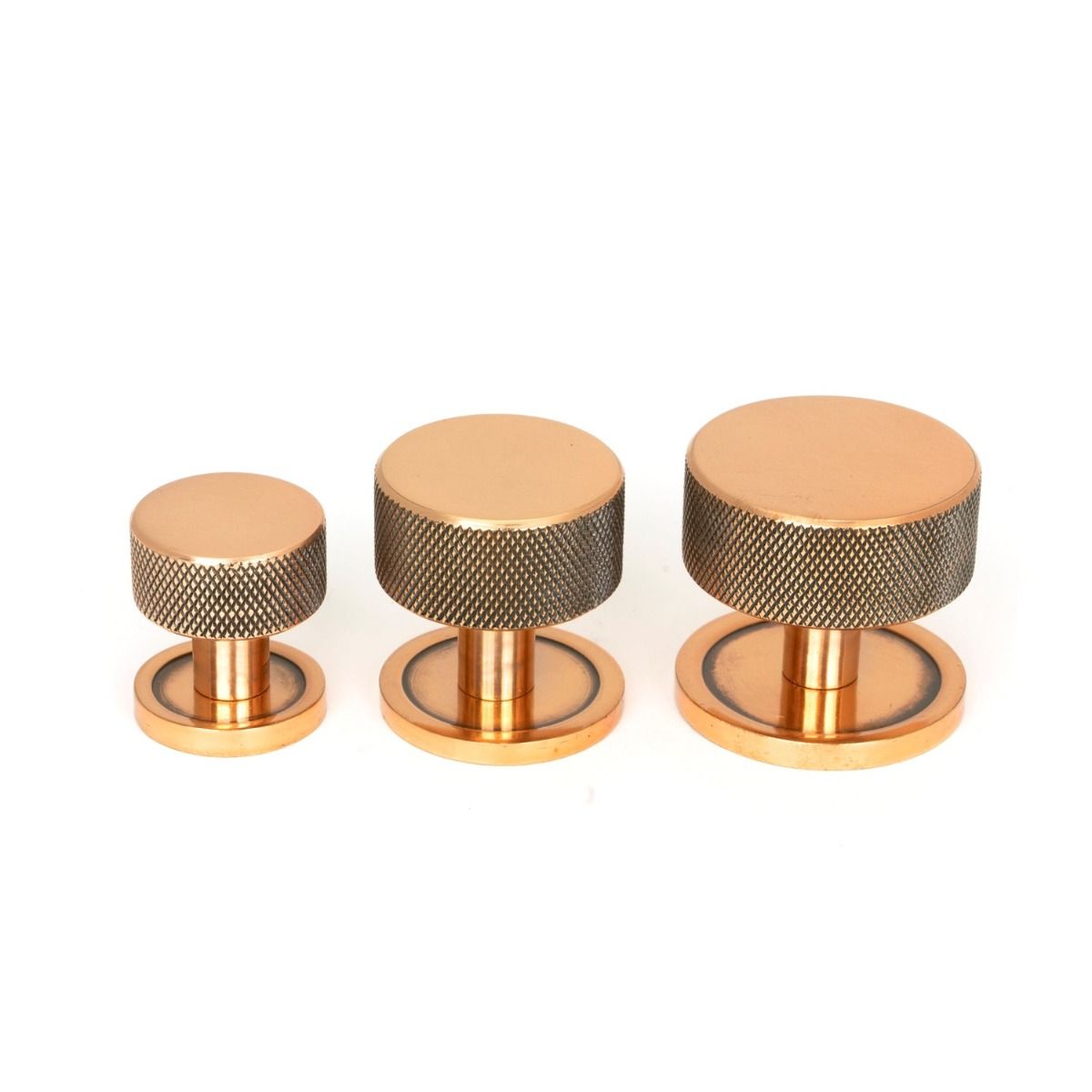 The 32mm Knurled Cabinet Knob on Plain Rose in Polished Bronze Alongside Different Sizes